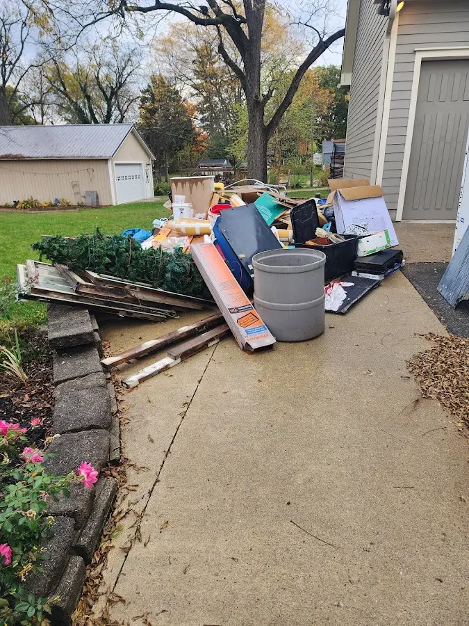 Dumpster being loaded with debris for Residential Dumpster Rental in Johnston